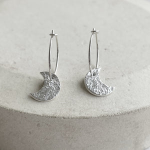 
                  
                    Sterling Silver Textured Moon Charm Hoops
                  
                