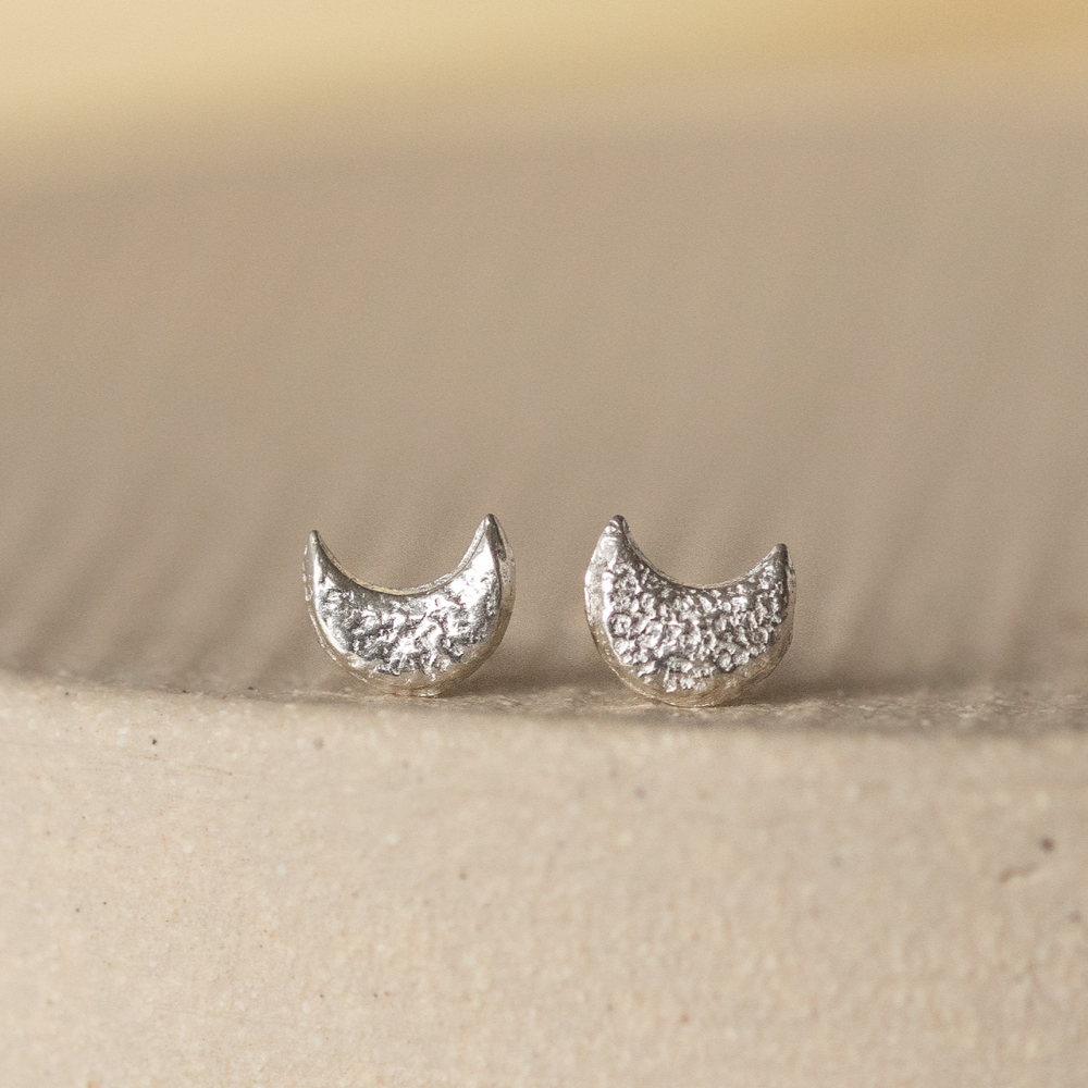 
                  
                    Sterling silver textured mini moon studs by Lucy Kemp Jewellery 
                  
                