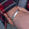 sterling silver personalised engraved cuff for men handmade by Lucy Kemp Jewellery - worn image