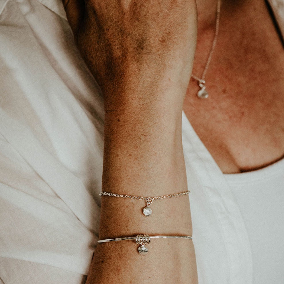 sterling silver Cornish shell charm bracelet - worn image with pendant and bangle, handmade by Lucy Kemp Jewellery