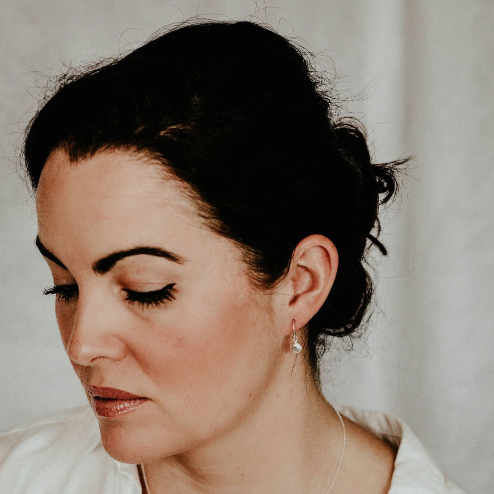 sterling silver Cornish shell charm earrings handmade by Lucy Kemp Jewellery -worn image