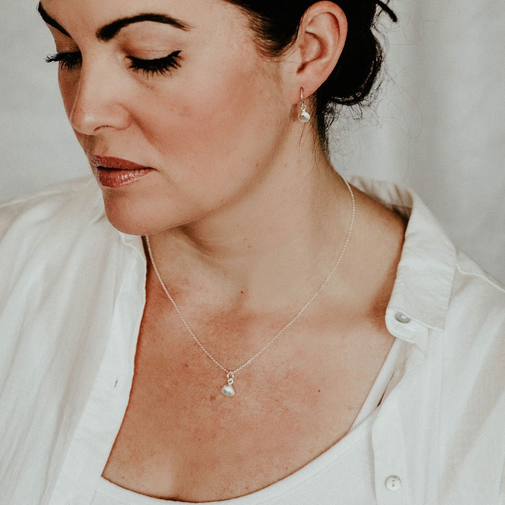 sterling silver cornish shell charm pendant and earrings worn image, handmade by Lucy Kemp jewellery 