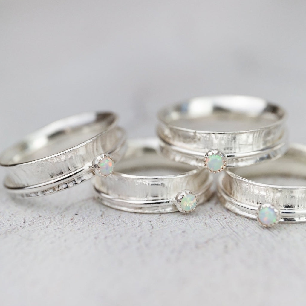 handmade sterling silver spinner rings with hammered texture and semi precious stones by Lucy Kemp Jewellery 
