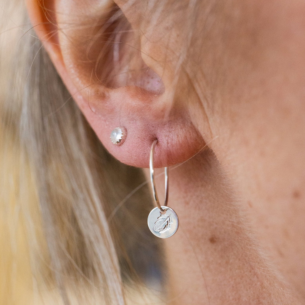 handmade sterling silver stamped leaf hoops worn, by Lucy Kemp Jewellery 