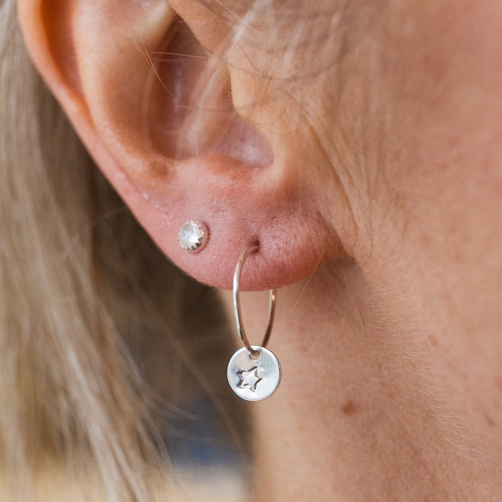 worn sterling silver stamped open star hoops