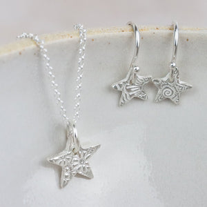 
                  
                    sterling silver small textured star pendant and earrings set by Lucy Kemp Jewellery
                  
                