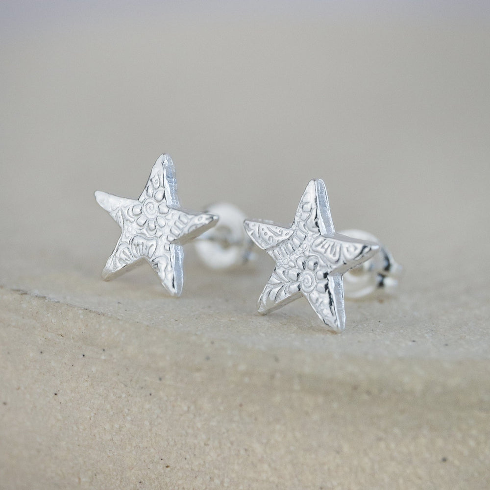 
                  
                    Sterling silver textured star studs by Lucy Kemp Jewellery 
                  
                