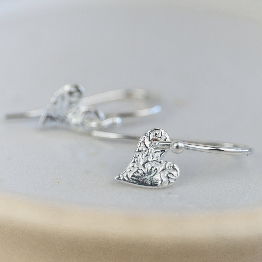 
                  
                    Handmade sterling silver mini textured tilted heart earrings by Lucy Kemp Jewellery 
                  
                