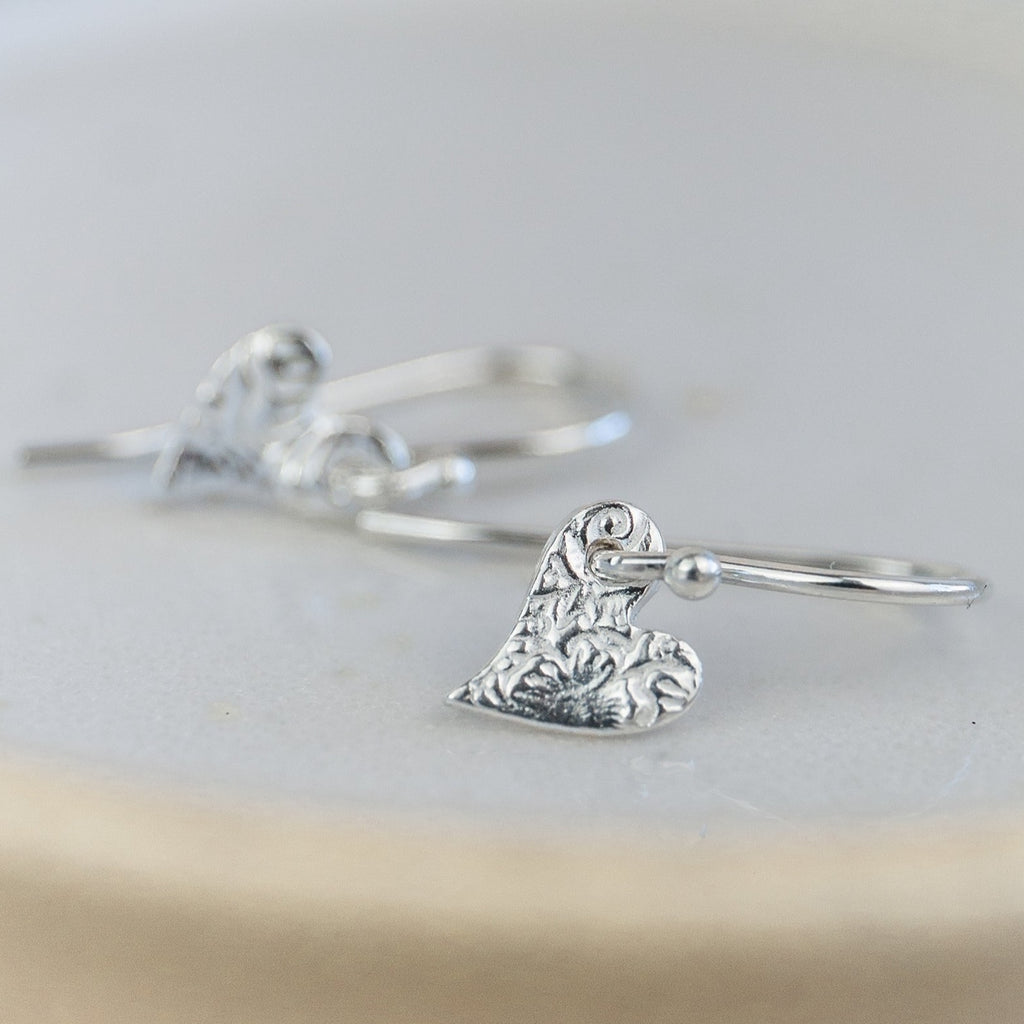 Handmade sterling silver mini textured tilted heart earrings by Lucy Kemp Jewellery 