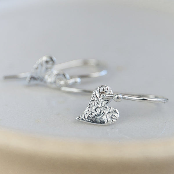 Handmade sterling silver mini textured tilted heart earrings by Lucy Kemp Jewellery 