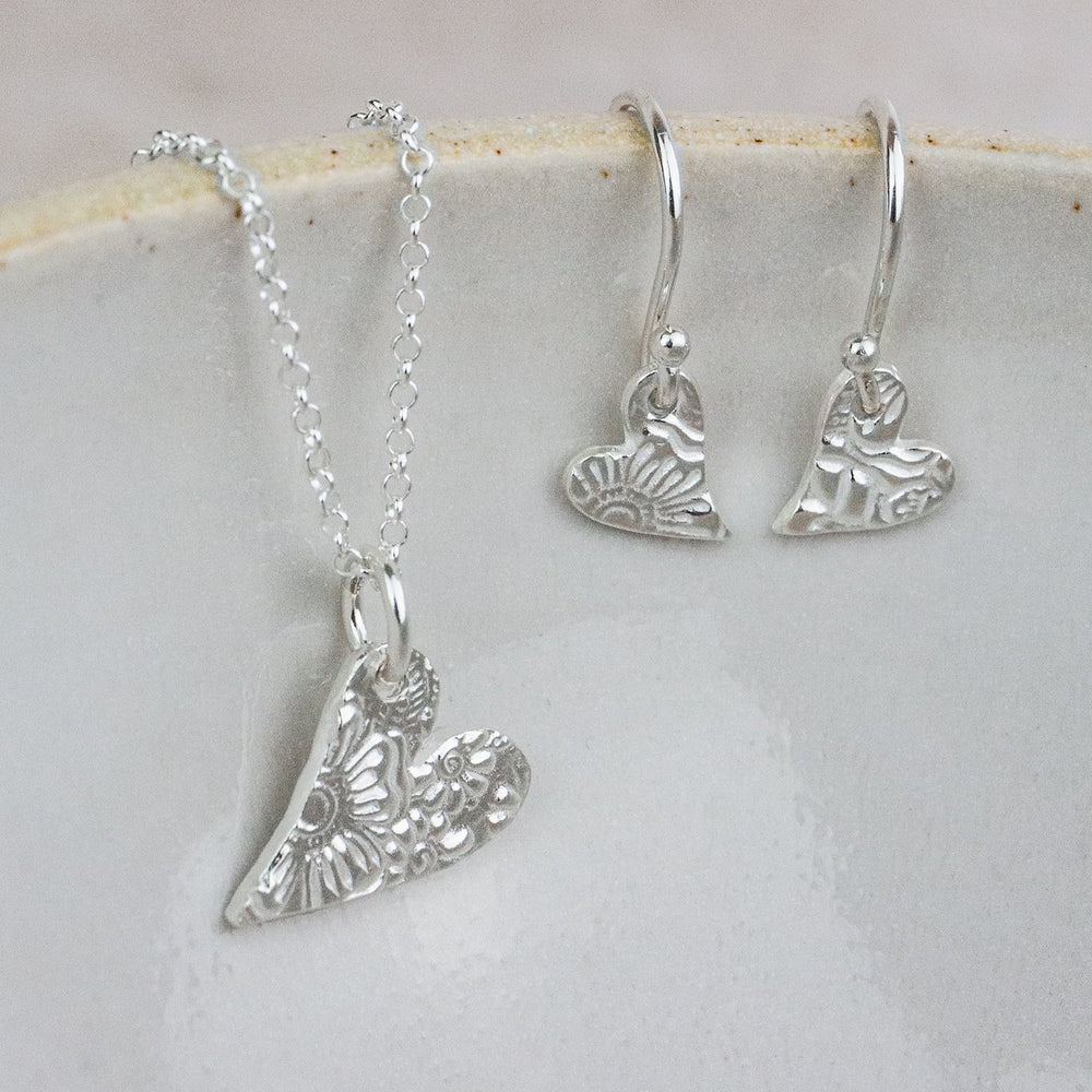 
                  
                    sterling silver small textured tilted heart pendant and earrings set by Lucy Kemp Jewellery
                  
                