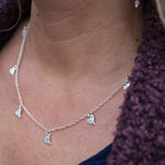 sterling silver short tilted heart charm necklace by Lucy Kemp Jewellery - worn image