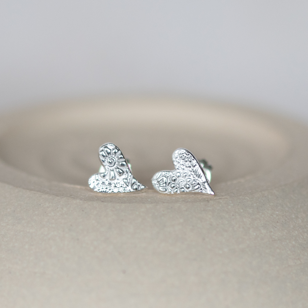 
                  
                    sterling silver textured tilted heart studs by Lucy Kemp Jewellery
                  
                